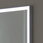 A bathroom mirror with a light on it.