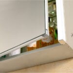 A mirror in a bathroom cabinet.