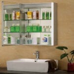 A bathroom with a sink and a glass cabinet.