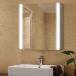 A bathroom with a sink and mirror above it.